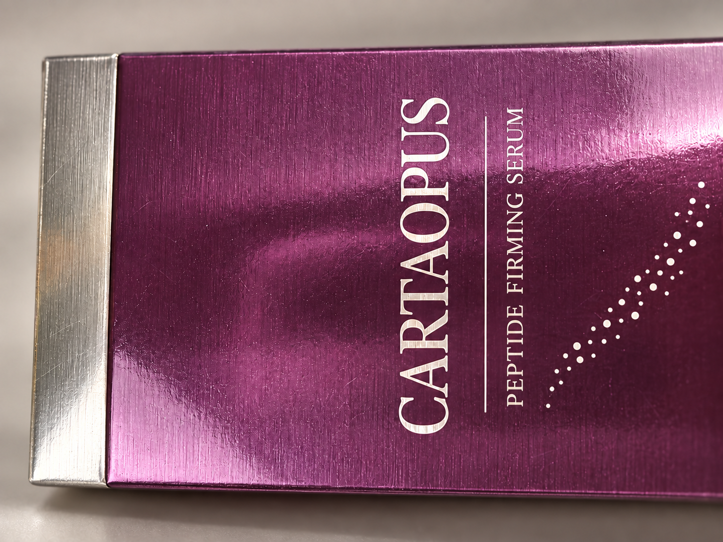 Close view of the same purple carton surface and light printed detail.