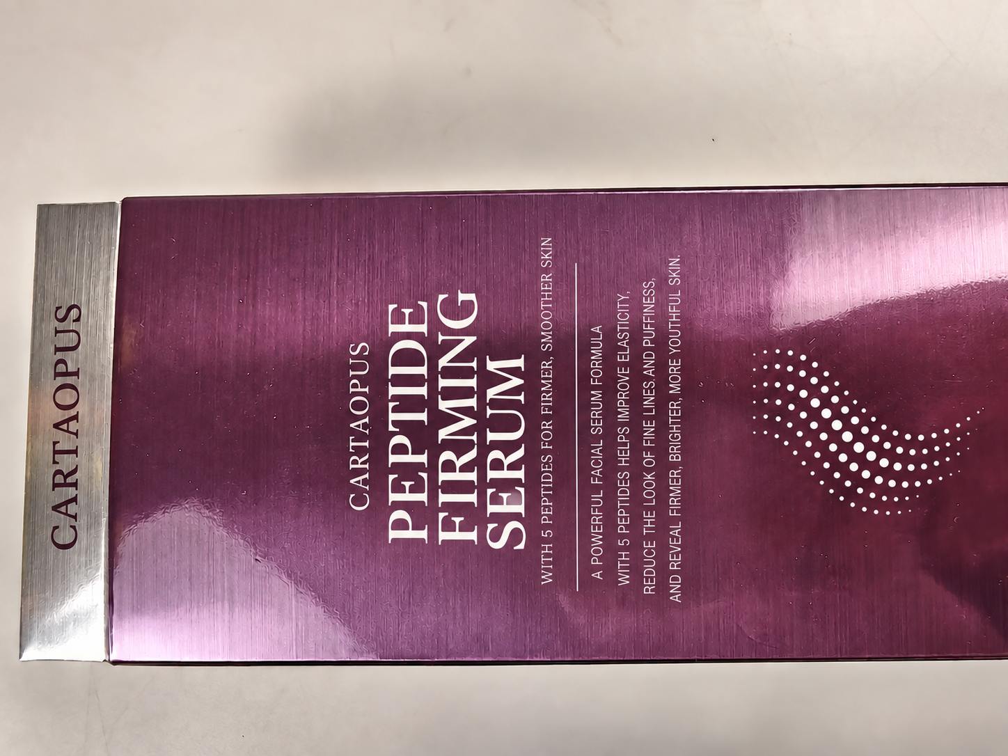 Overall view of a purple reflective folding carton.