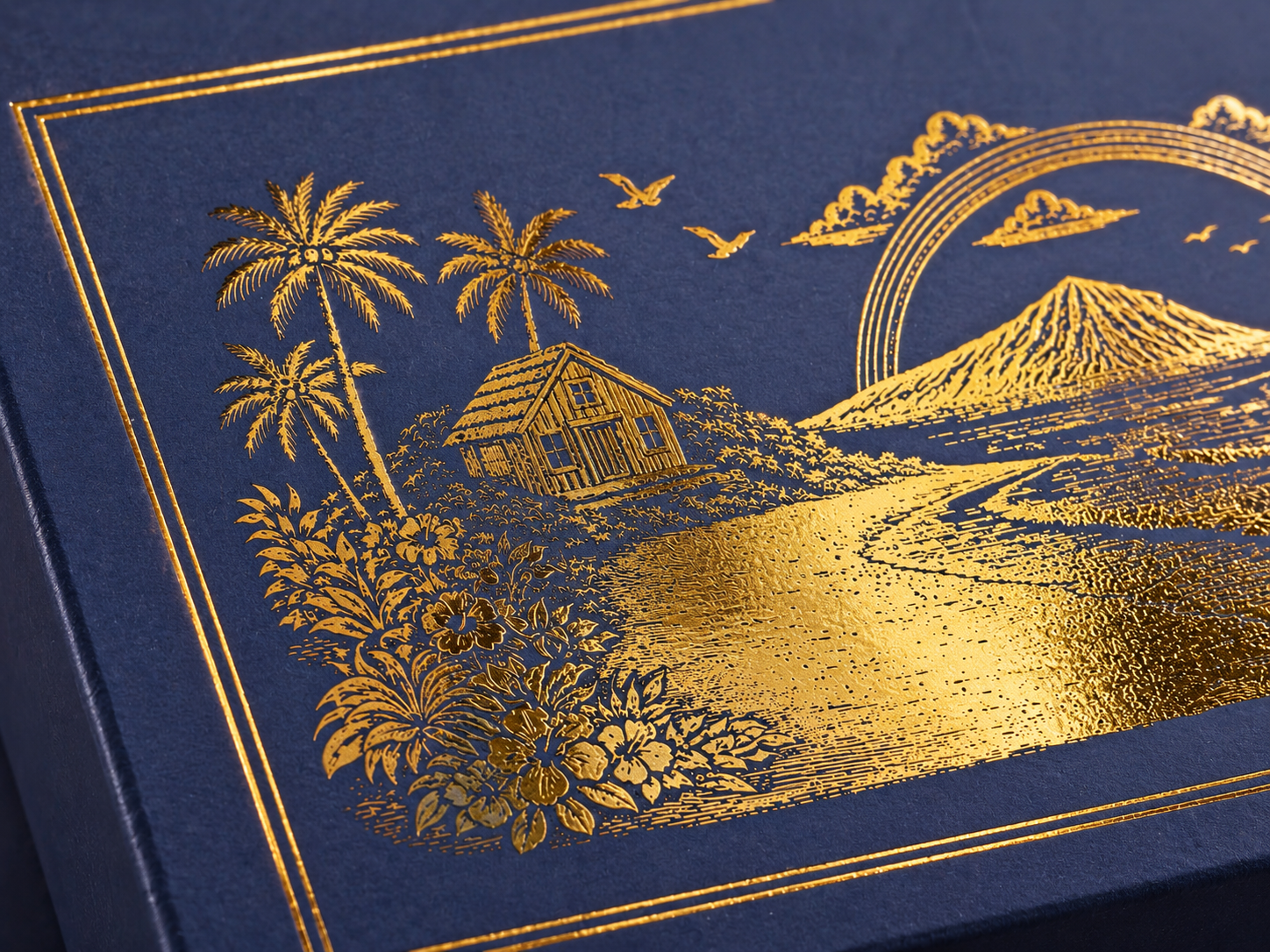 Close view of gold foil branding on the navy rigid box.