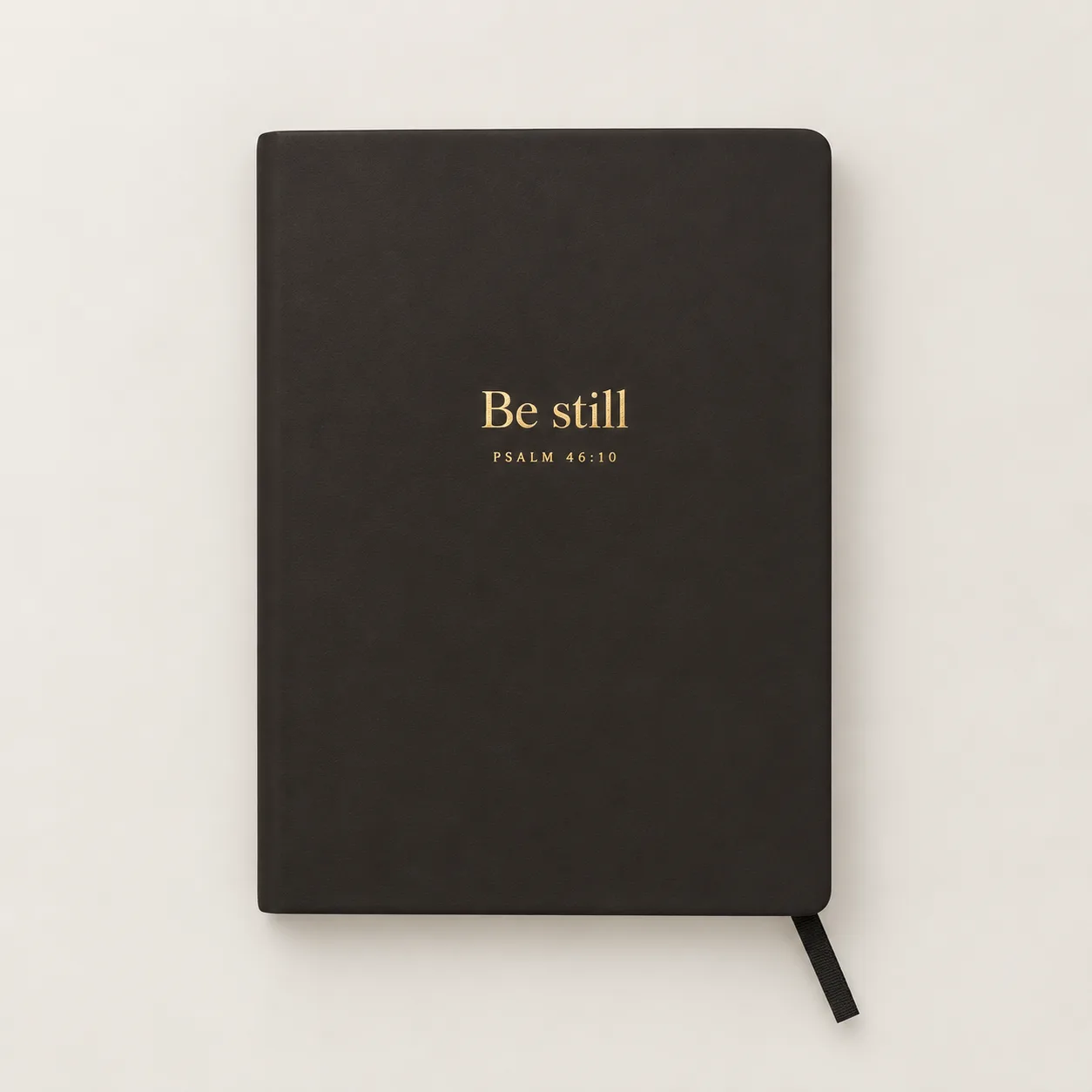 Dark notebook with a short phrase stamped in gold foil.