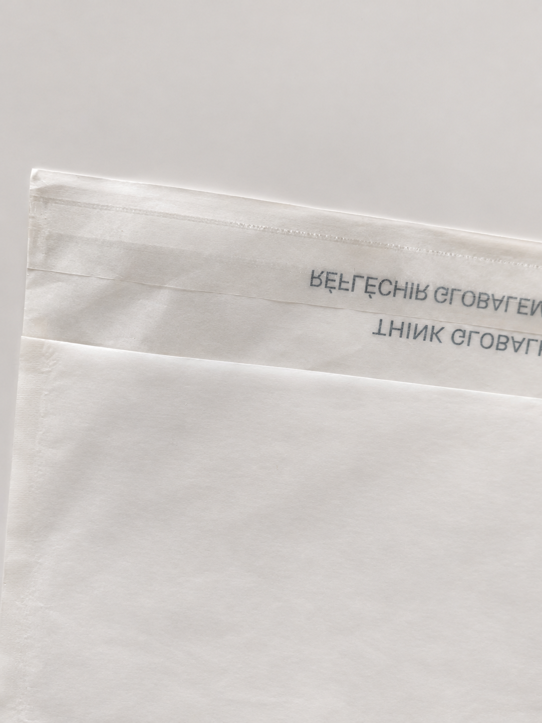 Close view of the closure area on a glassine paper bag.